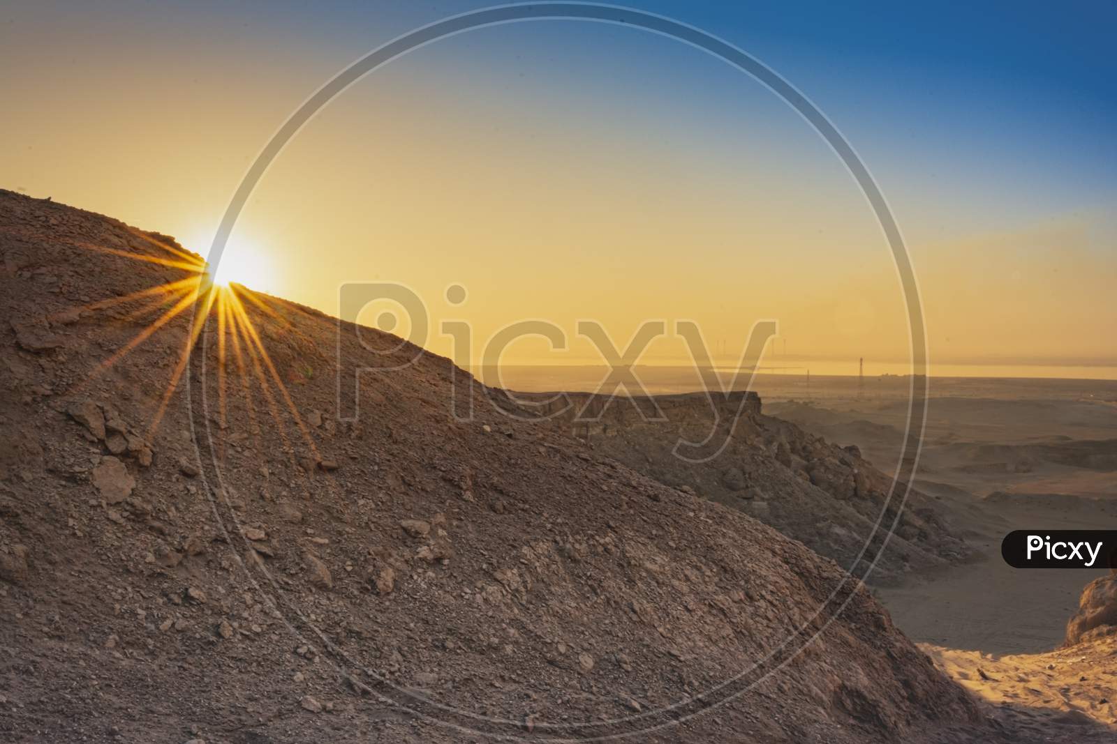 huge sand dunes with sun star in the arabian deserts in early morning sunrise