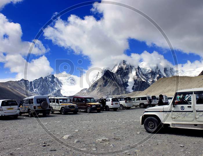 Snow Capped Mountains of Sikkim with Vehicles in the Foreground