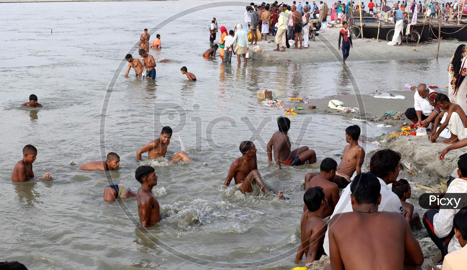 Hindu Devotees Takes Holy Dip In The Sangam, Confluence Of Three Rivers, The Ganga, The Yamuna And Mythical Saraswati After Lunar Eclipse Or Chandra Grahan In Prayagraj, June 6, 2020.