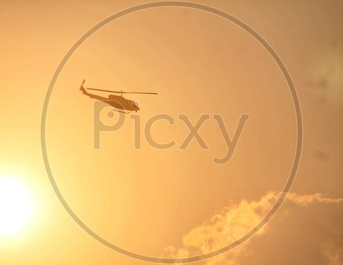Bell 206 helicopterpassing behind the sun