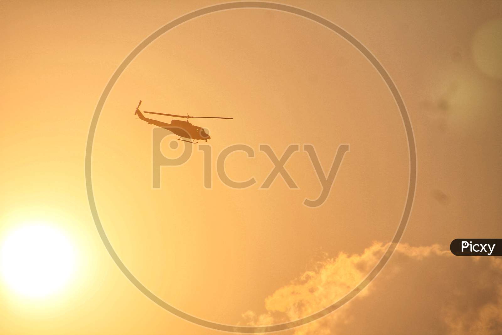 Bell 206 helicopterpassing behind the sun