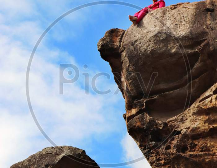 A Women on the edge of a mountain Cliff