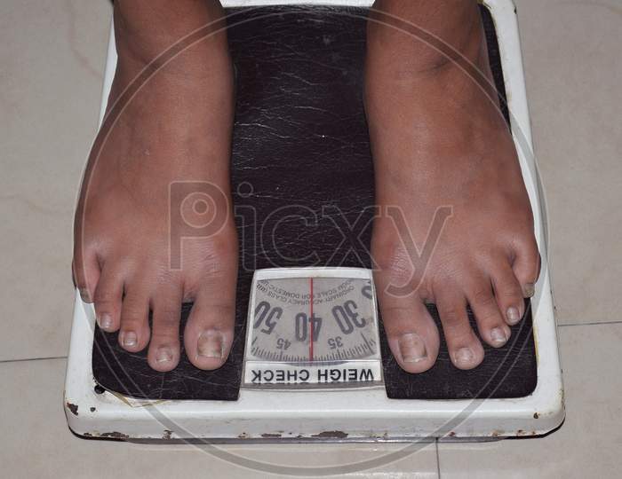 A person on Weighing Machine