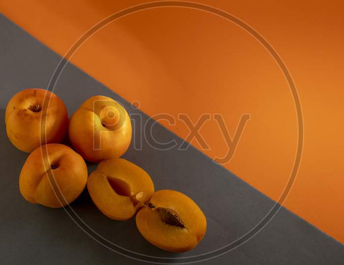 Juicy peach on a orange and grey background.