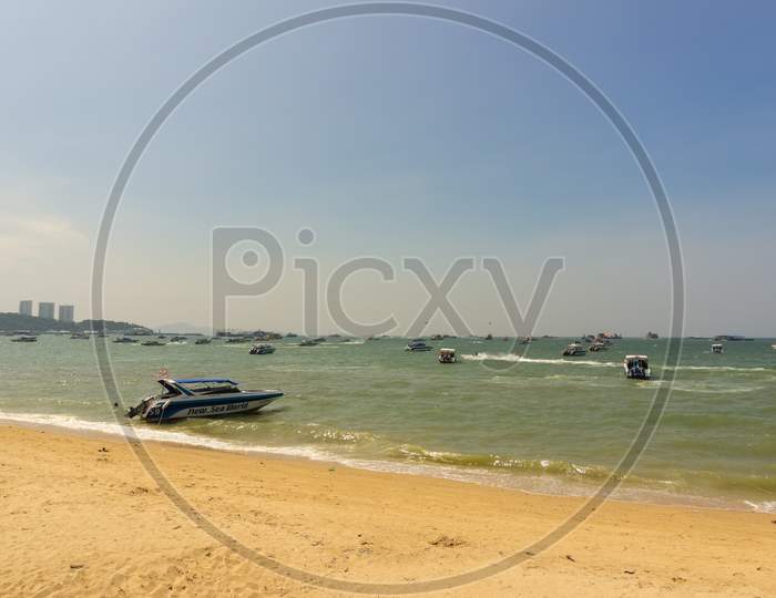 Pattaya,Thailand - October 13,2018: The Beach Tourists Relax And Swim There And Rent Boats For Trips.Some Thai People Sell Souvenirs,Food And Drinks To Them.