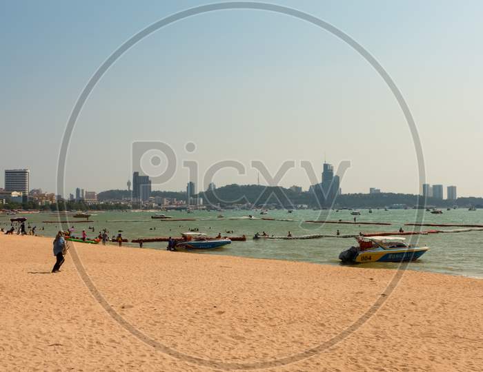 Pattaya,Thailand - April 13,2018: The Beach Tourists Relax And Swim There And Rent Boats For Trips.Some Thai People Sell Souvenirs,Food And Drinks To Them.