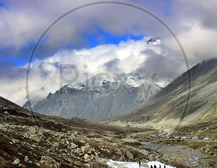 Snow Capped Mountains of Sikkim with People in the foreground