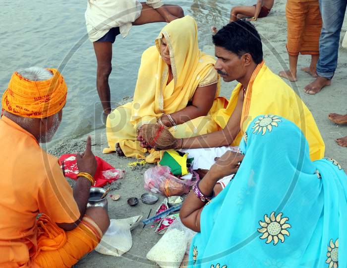 Hindu Devotees Offering Prayers After Takes Holy Dip In The Sangam, Confluence Of Three Rivers, The Ganga, The Yamuna And Mythical Saraswati After Lunar Eclipse Or Chandra Grahan In Prayagraj, June 6, 2020.