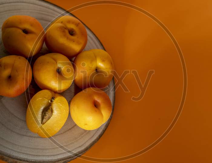 Peach on a wooden dish