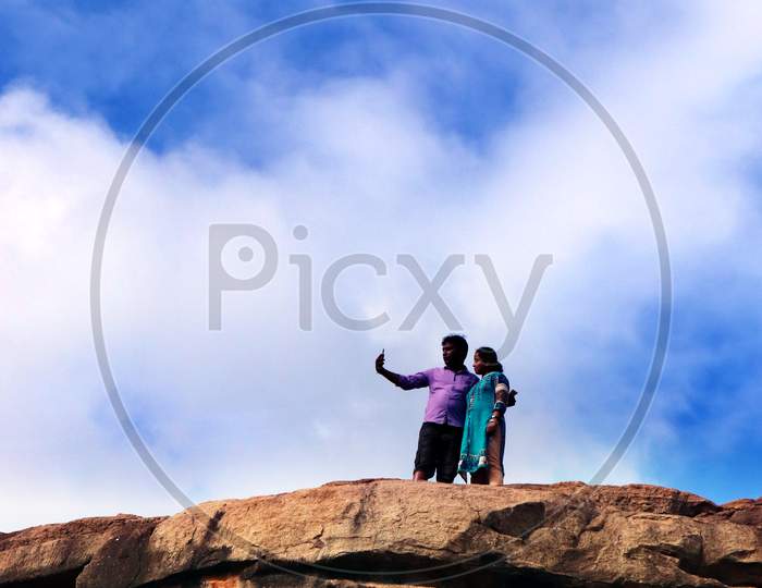 People talking Photos by standing on mountain Cliff