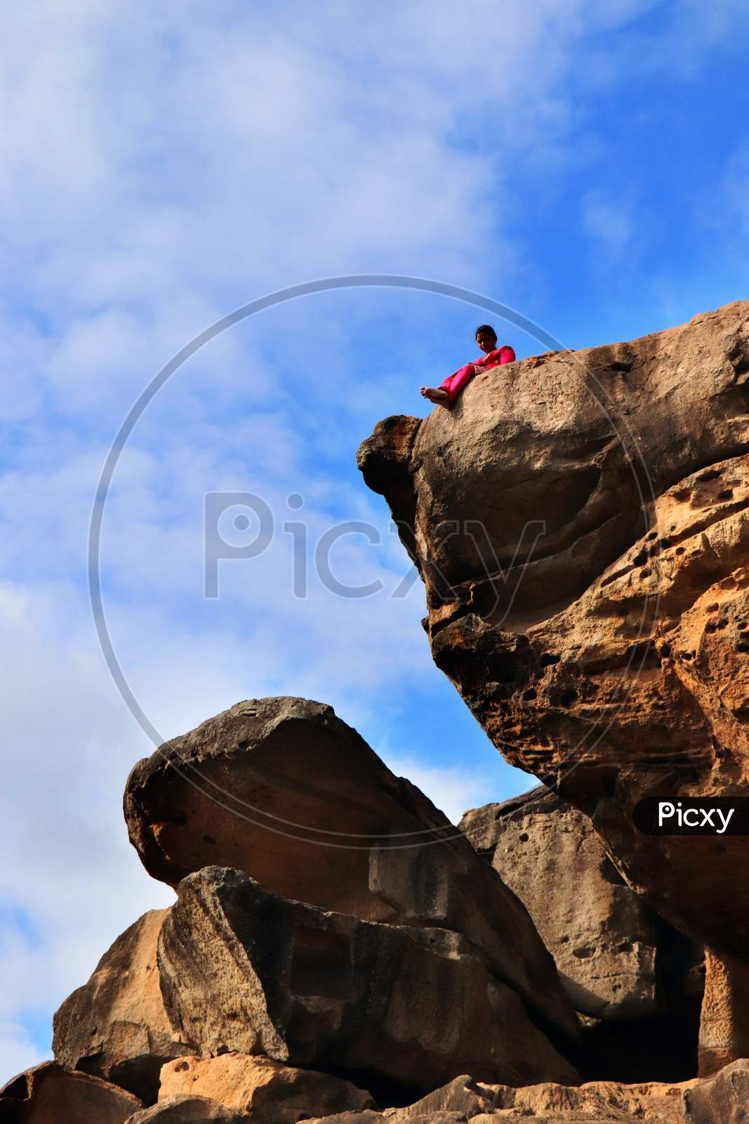 A Women on the edge of a mountain Cliff