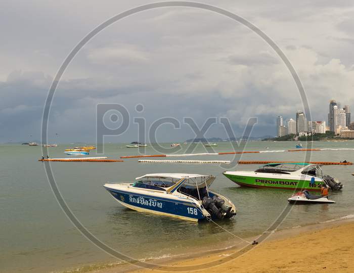 Pattaya,Thailand - October 21,2018: The Beach Tourists Relax And Swim There And Rent Boats For Trips.Some Thai People Sell Souvenirs,Food And Drinks To Them.