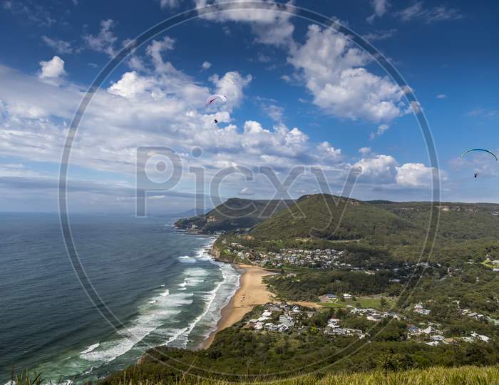 Traveling along the Great Ocean Road in Victoria, Australia at a sunny day in summer. Visiting a view point with paraglider.