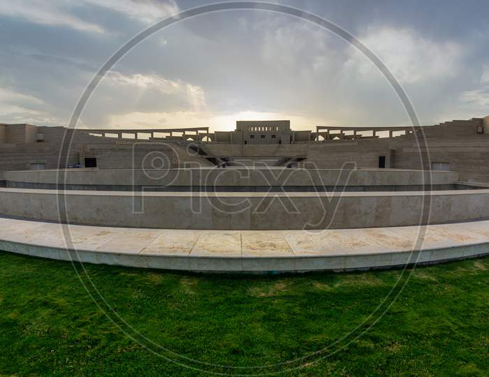 The amphitheater in Katara Cultural Village, Doha Qatar panoramic view in daylight clouds in the sky in background.