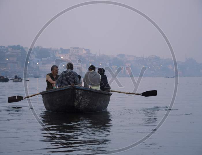 Varanasi, India, 23.01.2018 : Tourists are visiting on boats in the Ancient city of India, Varanasi. Indian culture, travel and tourism