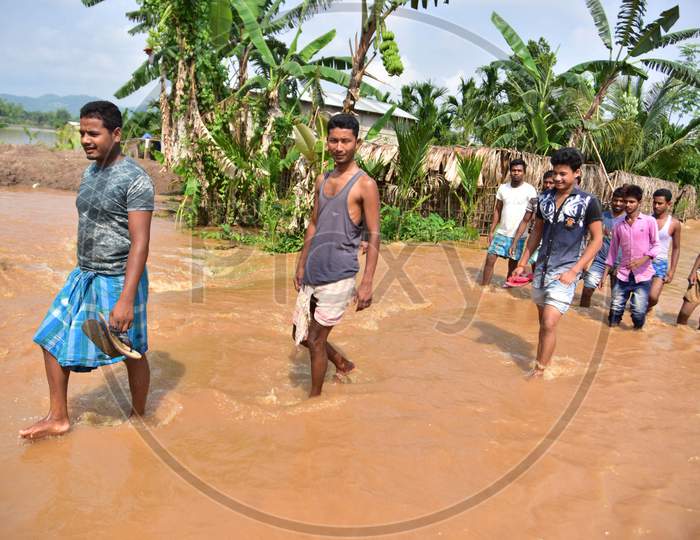 Villagers Wade Through Flooded Waters At  Pramila Village Near Kampur In Nagaon District Of Assam On June 7,2020