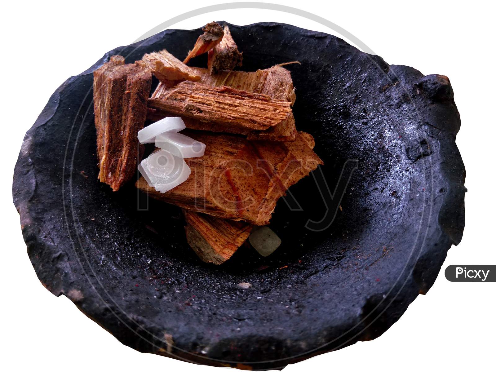 Small pieces of wood and Camphor Tablets (known as Karpoor or karpur in Hindi) used for producing fire during the worship of God in Hindu kept in a clay pot.