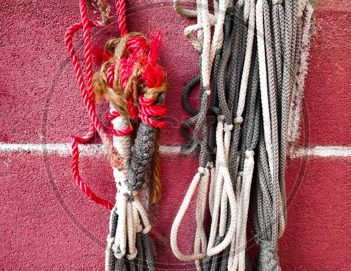 nylon rope , parachute cord on a red brick wall