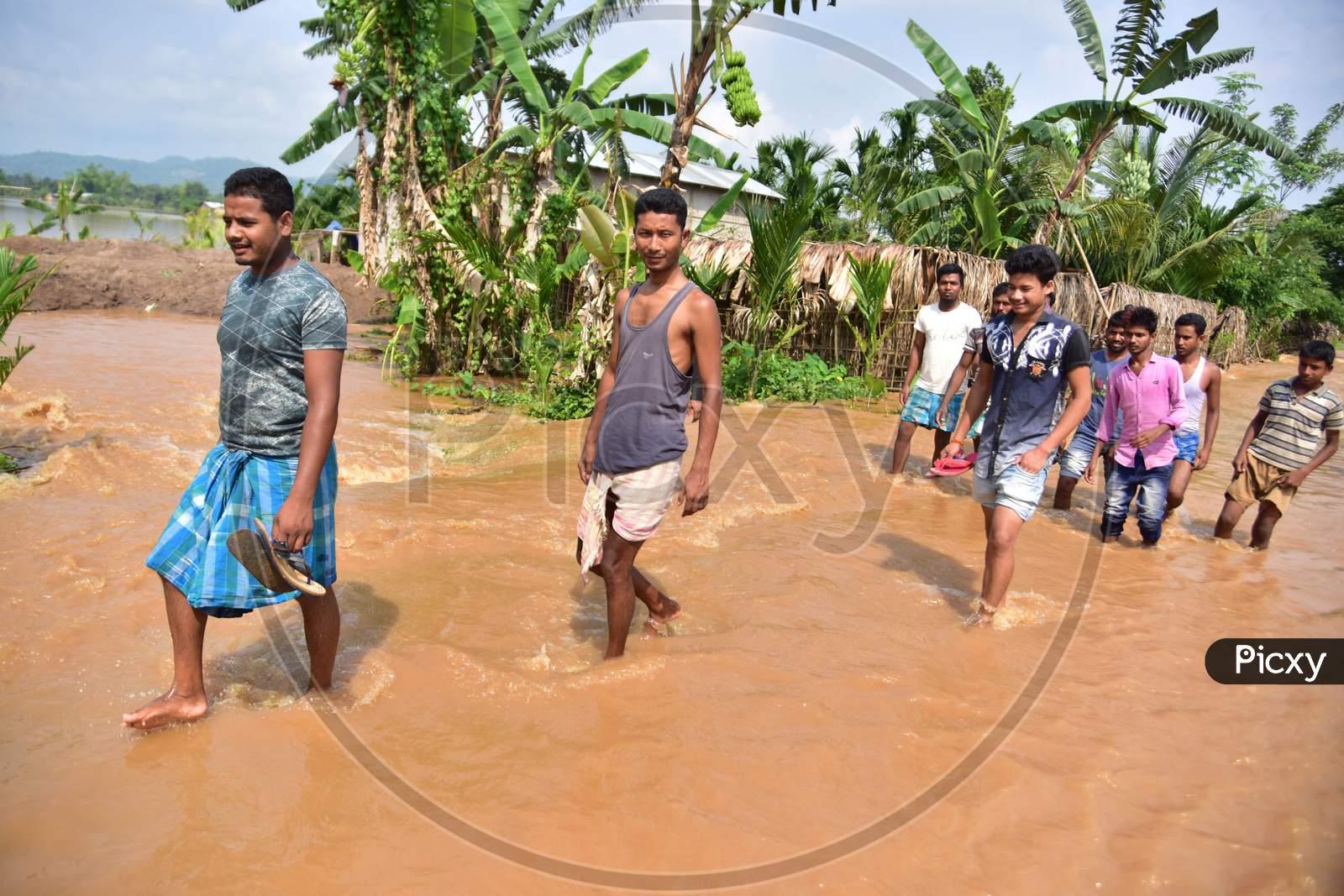 Villagers Wade Through Flooded Waters At  Pramila Village Near Kampur In Nagaon District Of Assam On June 7,2020