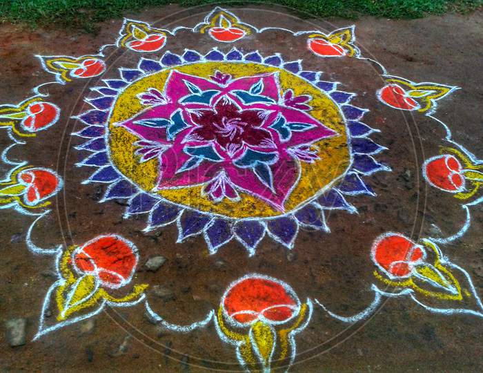 Rangoli (Floral design):is a creative design that is made on the floors of the courtyard of the house, office premise and living room. It is a tradition that has been followed from  many ages in India