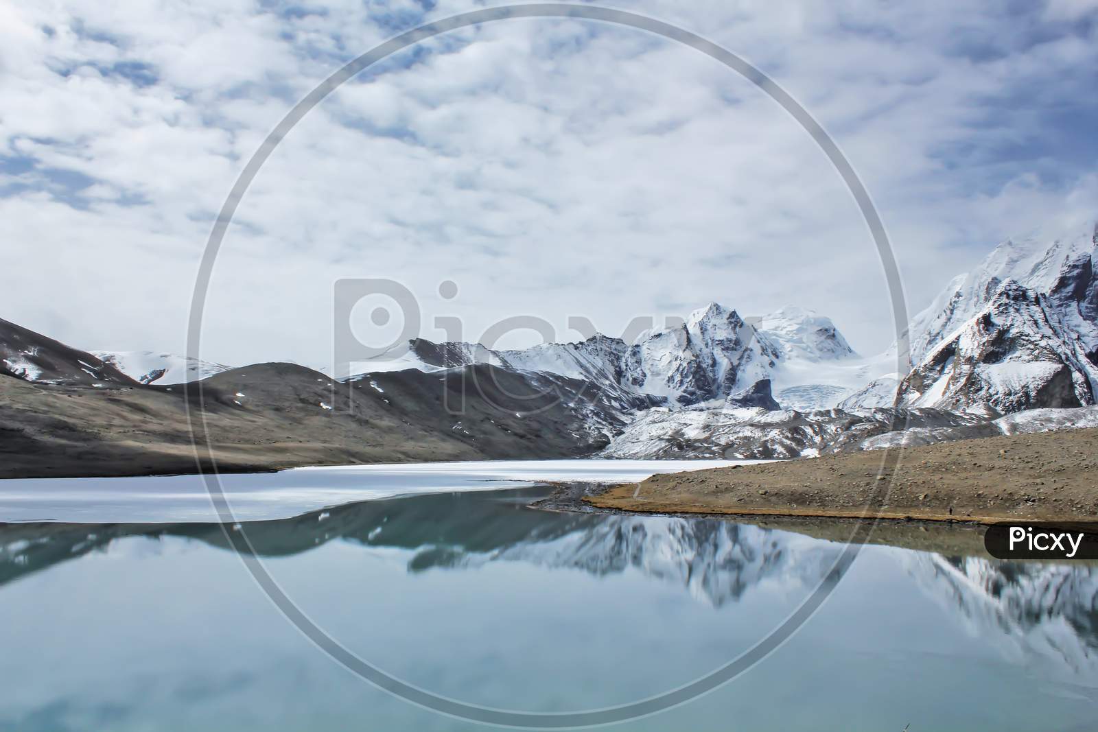 India Gurudongmar Lake, Sikkim.
Encircled All Around By Snow-Covered Mountains The Lake Freezes During The Winter