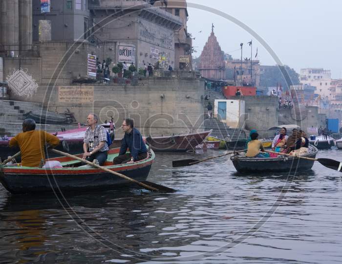 Varanasi, India, 23.01.2018 : Tourists are visiting on boats in the Ancient city of India, Varanasi. Indian culture, travel and tourism