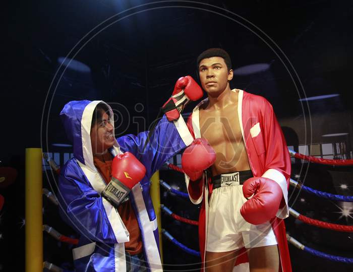 Visitors pose with world-class boxer wax statue of Muhammad Ali
