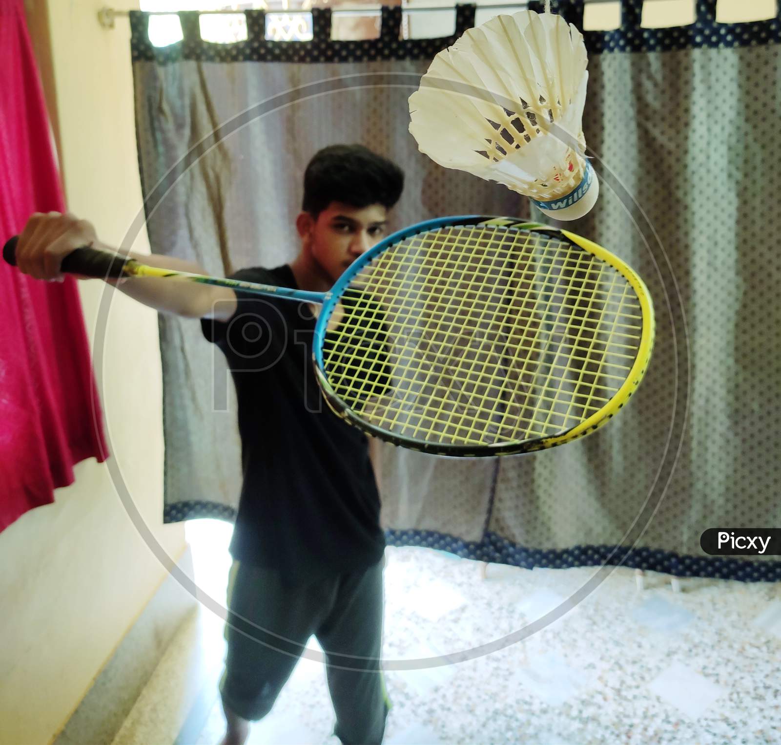 A boy playing badminton