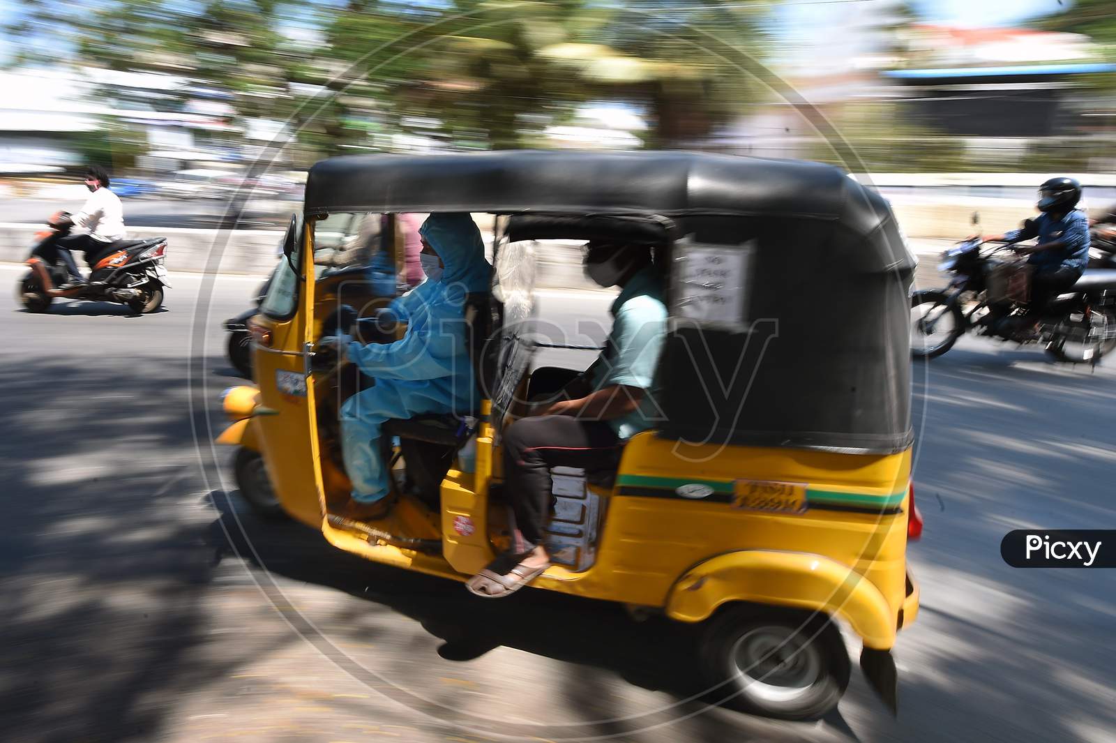 A auto rickshaw Driver Wearing Personal Protective Equipment (Ppe) Drives His Customers in Chennai, Tamil Nadu