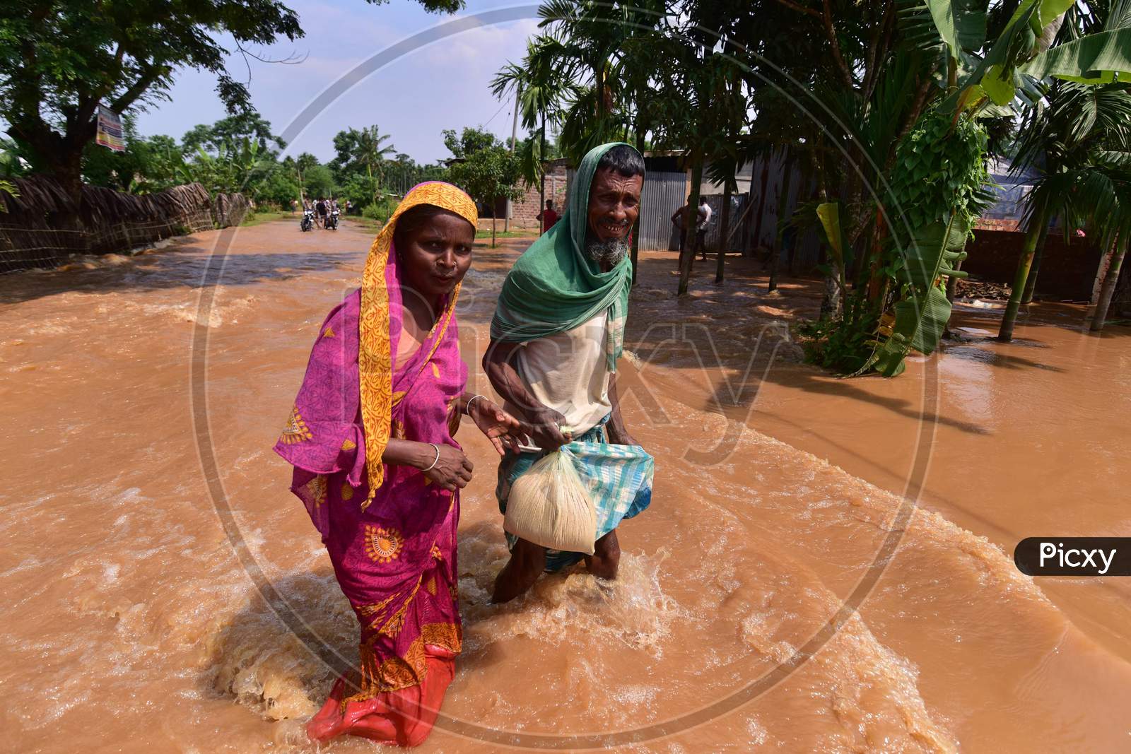 Villagers  Wade Through A Flooded Area To Reach A Safer Place At  Pramila Village Near Kampur In Nagaon District Of Assam On June 7,2020