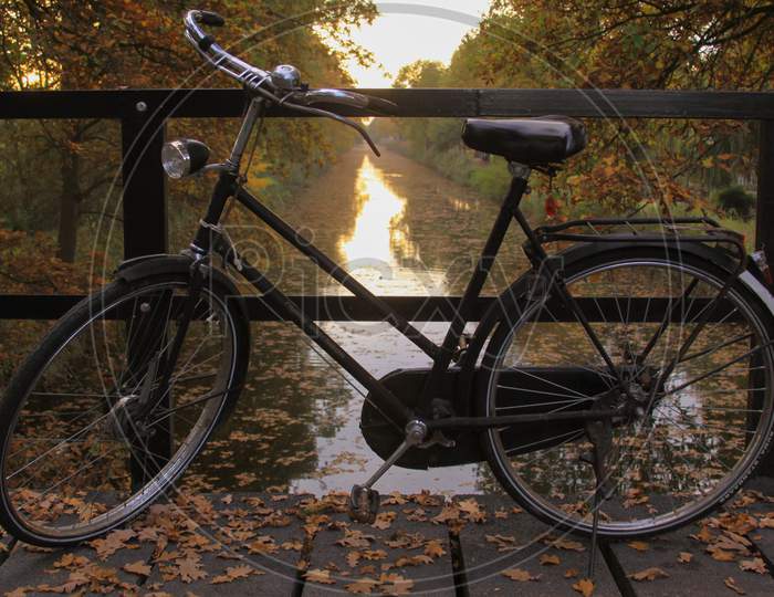 Bicycle On A Bridge At Sunset, In The Netherlands