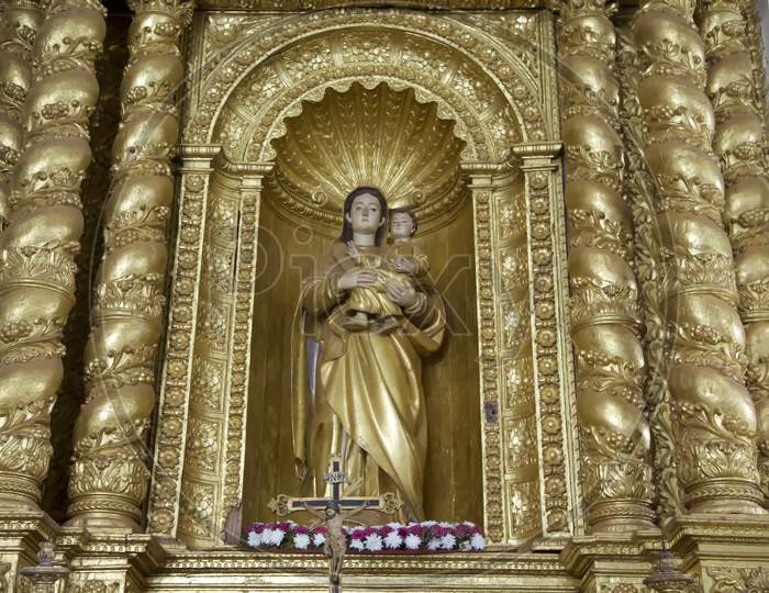 Statue Of Our Lady. A Golden Statue Of The Virgin Mary Inside The Basilica Of Bom Jesus, Goa.India