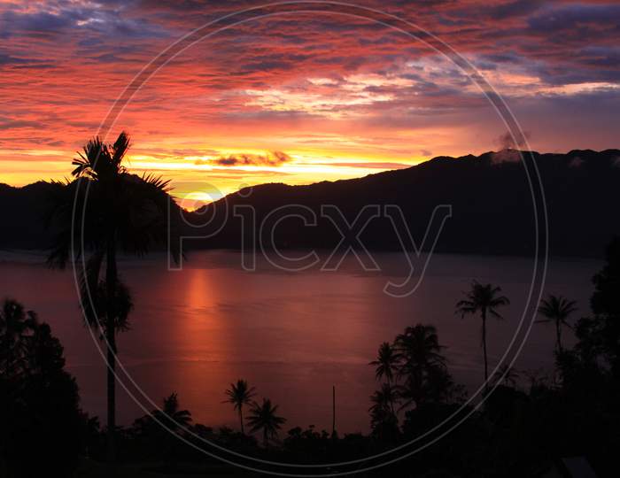 Beautiful Sunset With Palm Trees On Lake Maninjau