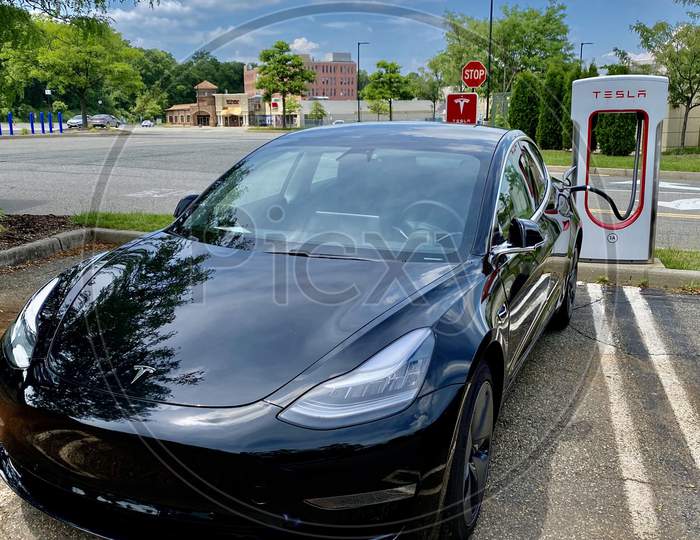 Tesla Model 3 and Supercharger