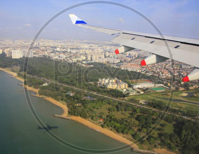 Singapore's clean, green coastline is seen from aircraft