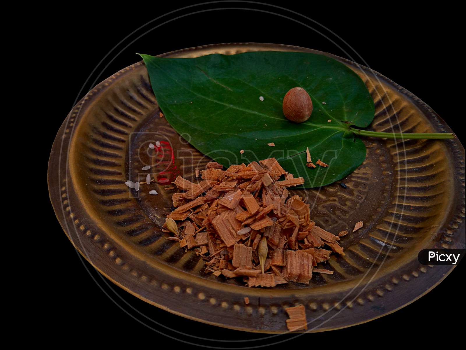 Betel leaf and small pieces of wood served on a aluminum plate are some of the things which are required during the prayer or worship in hindu.