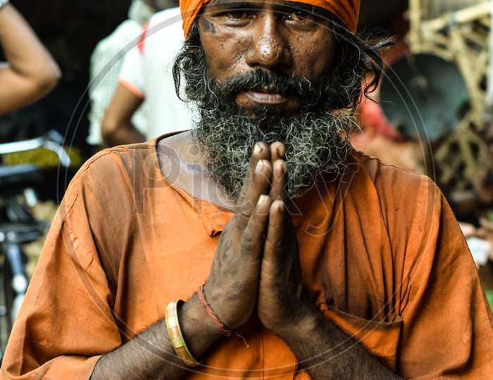 Bareilly, Uttar Pradesh / India - September 2018 : Old Sadhu poising with Namaste in spiritual Orange clothing