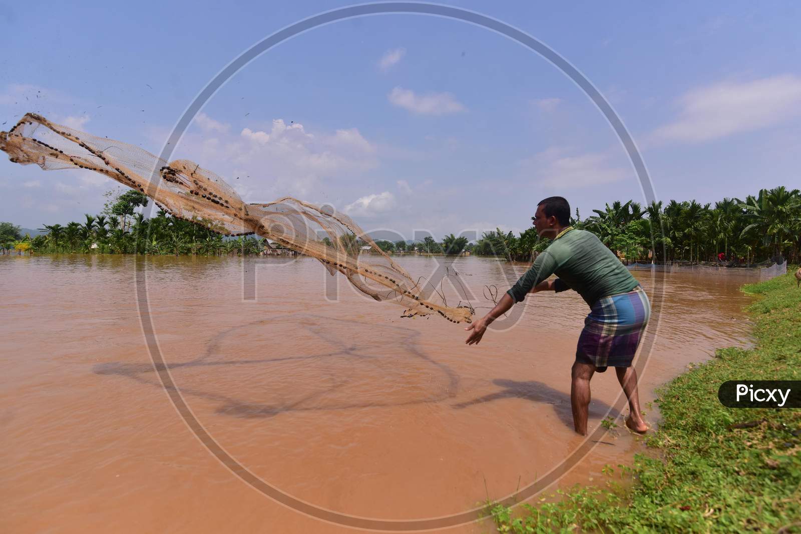 A  Villager Fishing On Flood Water At  Pramila Village Near Kampur In Nagaon District Of Assam On June 7,2020.