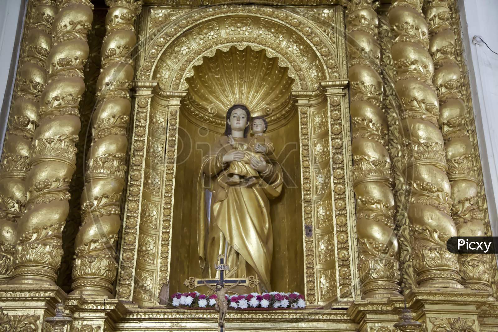 Statue Of Our Lady. A Golden Statue Of The Virgin Mary Inside The Basilica Of Bom Jesus, Goa.India