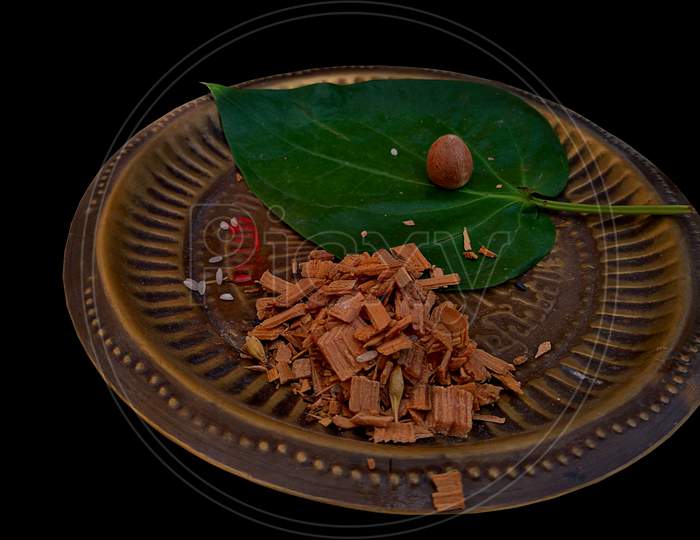 Betel leaf and small pieces of wood served on a aluminum plate are some of the things which are required during the prayer or worship in hindu.