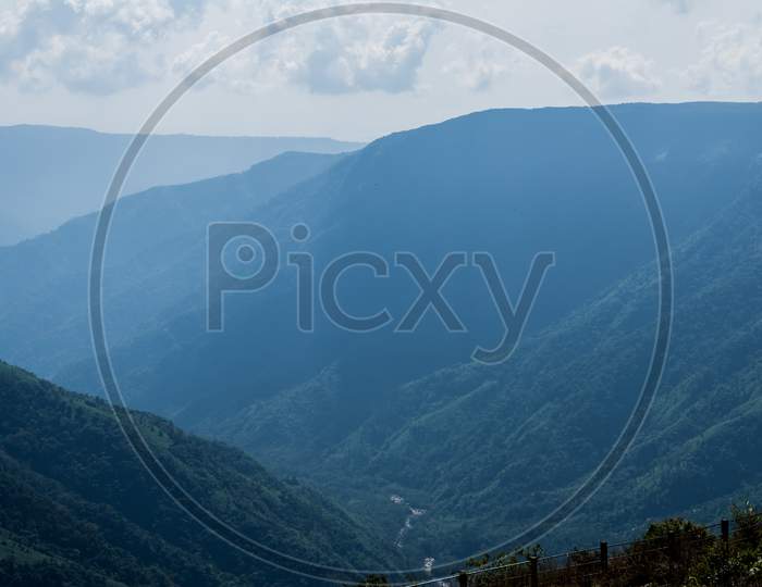 Natural view of the folded mountains and lush green valleys with clear sky and clouds of Cherrapunji, Meghalaya, North East India