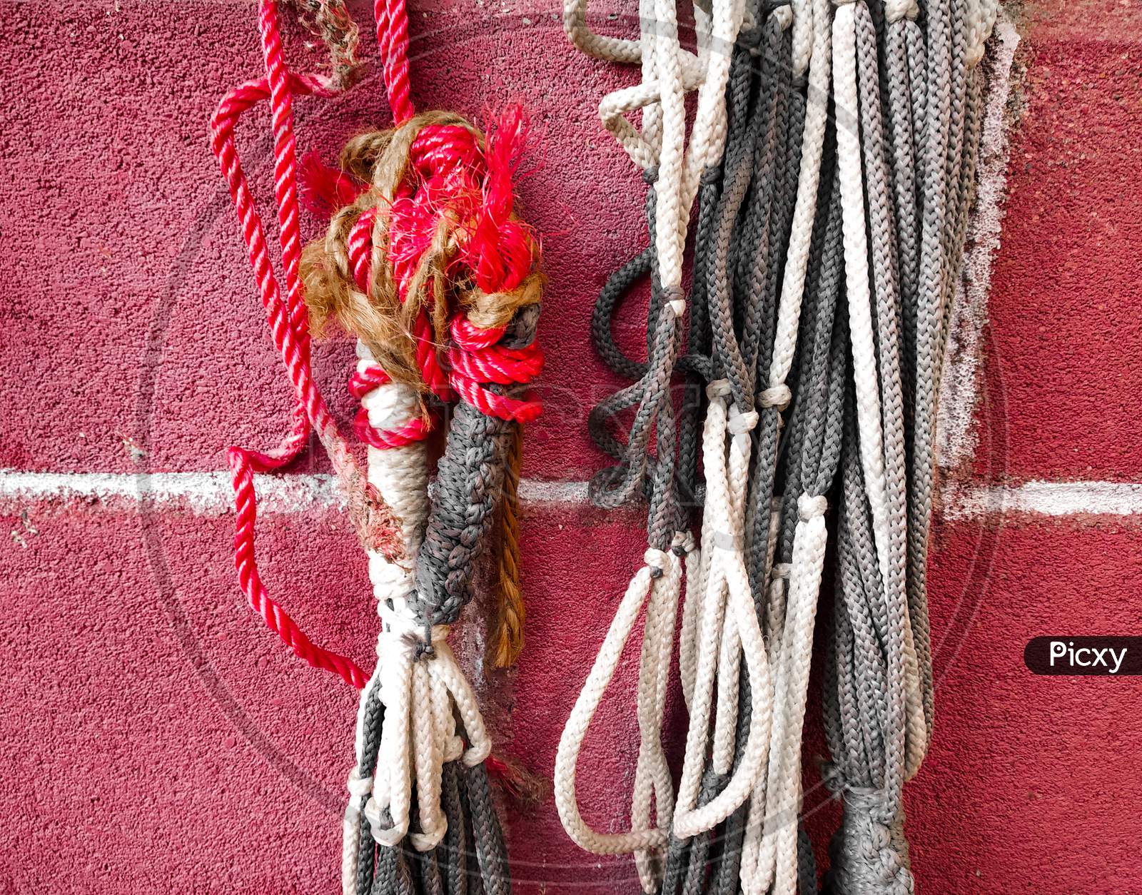 nylon rope , parachute cord on a red brick wall