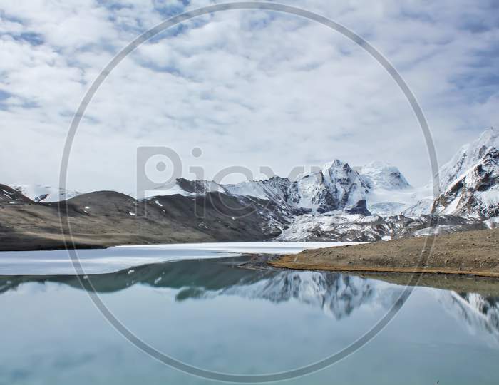 India Gurudongmar Lake, Sikkim.
Encircled All Around By Snow-Covered Mountains The Lake Freezes During The Winter