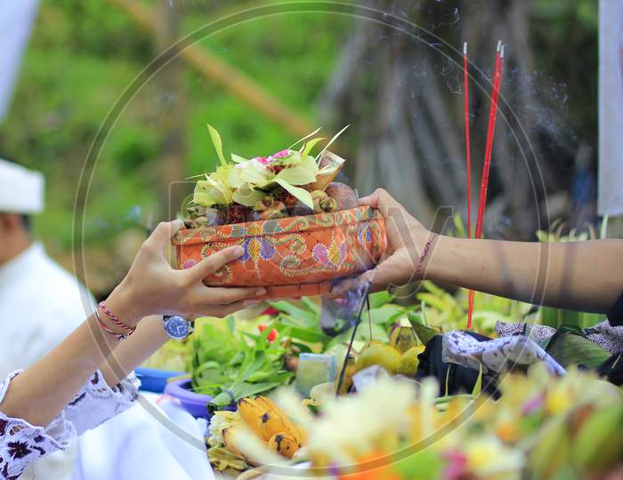 The offerings in the form of various foods, drinks, and objects that are considered to symbolize world enjoyment are offered by Hindus to be banned in the Melasti