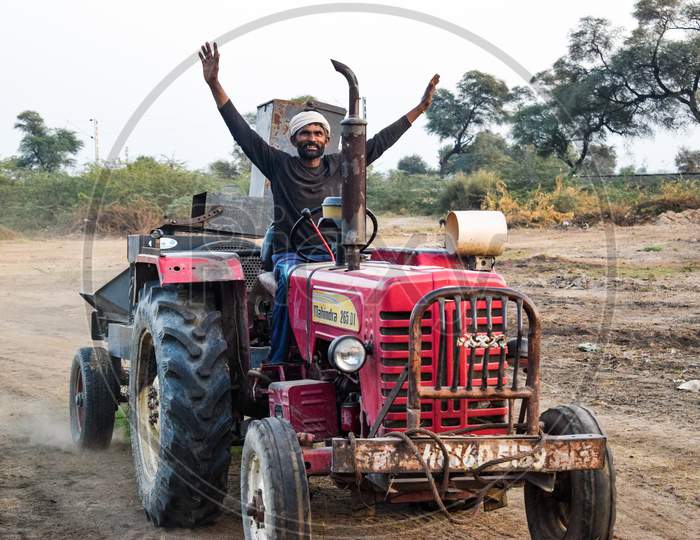 Khatu Shyam, Rajasthan / India - October 15, 2019 : Farmer enjoying on tractor after favorable new for agriculture sector