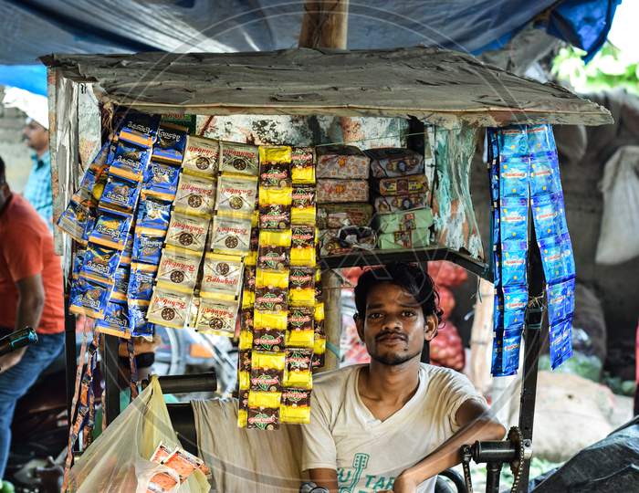 Handicap man selling tobacco pouch on his wheelchai. A respectable way to earn for his living
