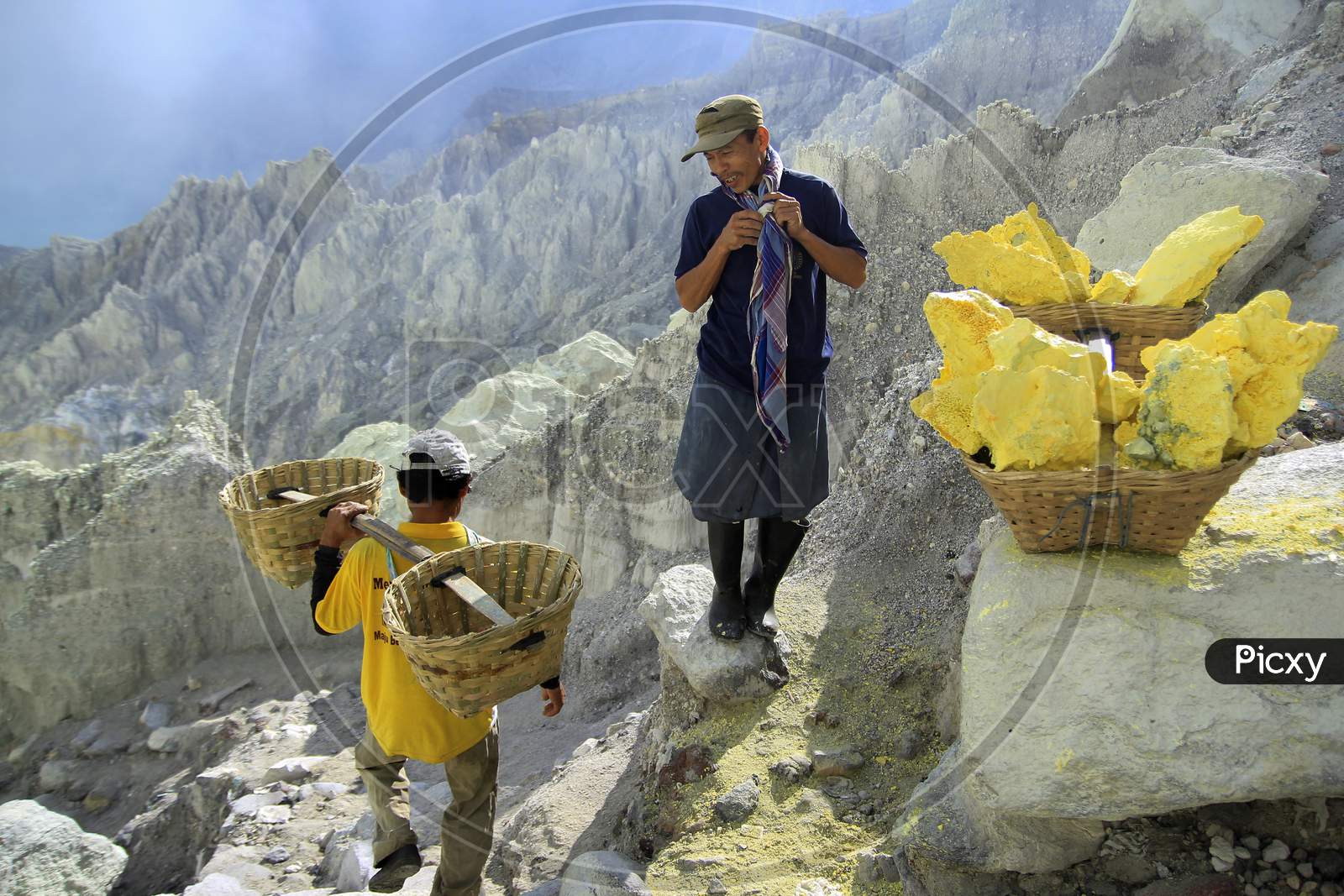 Sulfur Miners take a short break when carrying sulfur