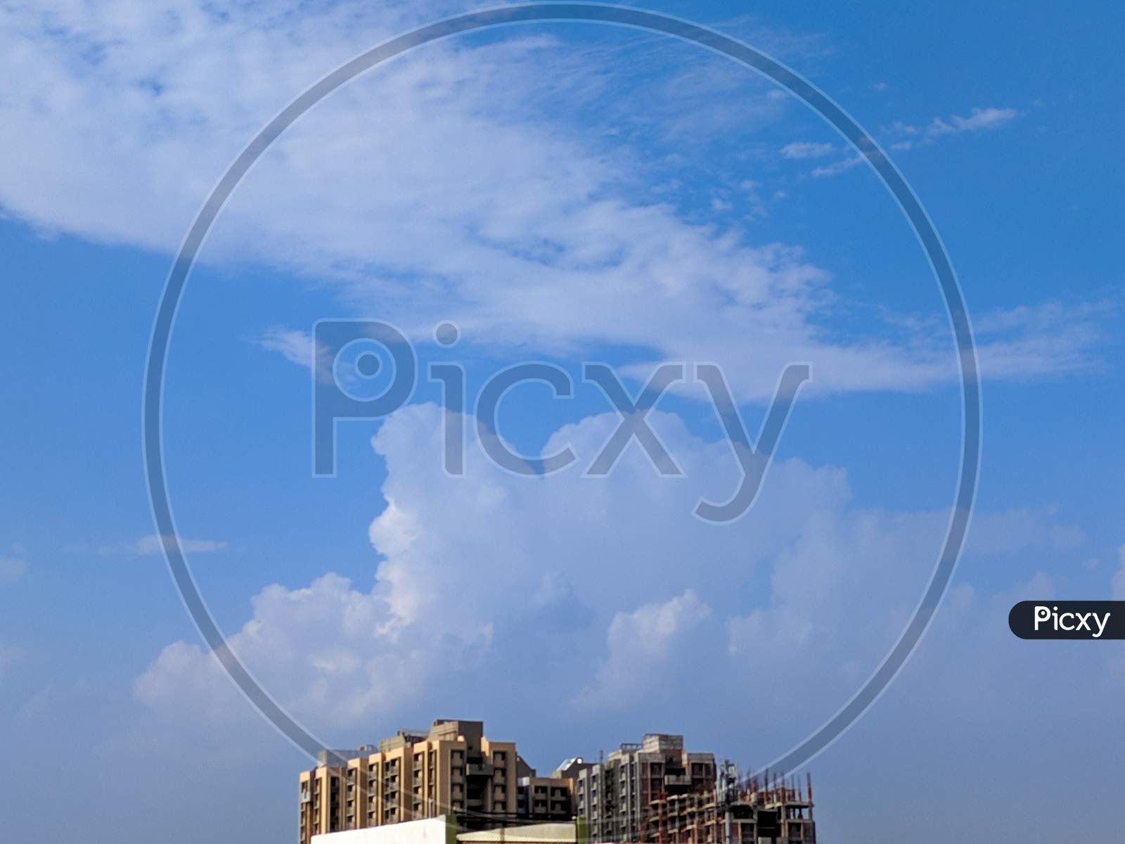 Top of the building with blue clouds