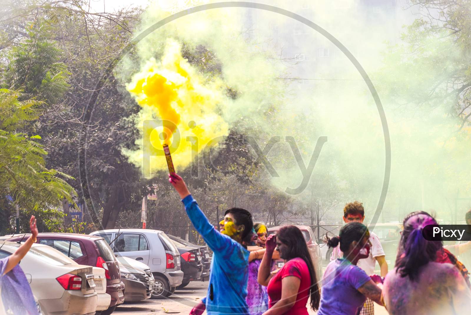 New Delhi, Delhi / India - March 04, 2019: Children playing with colorful smoke and celebrating the festival of holi in India.