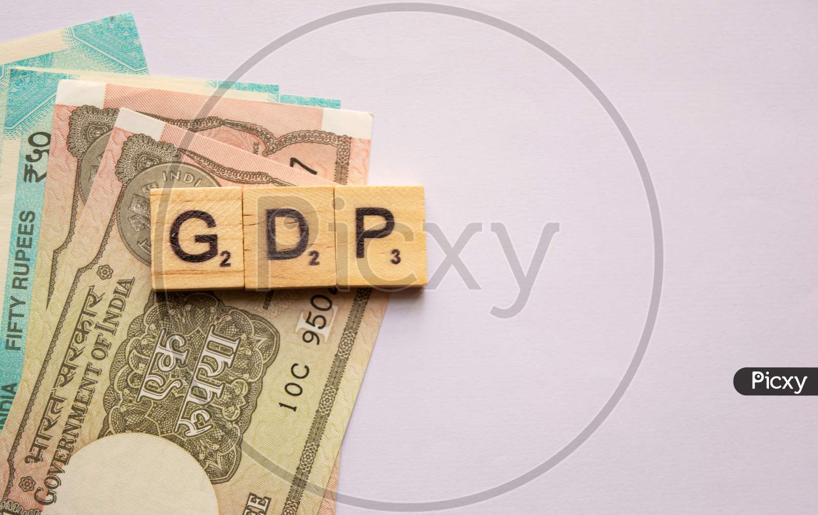 Gdp Or Gross Domestic Product In Wooden Block Letters With Indian Currency On Isolated Background.